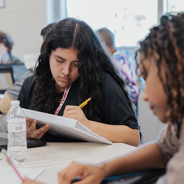 Student taking notes in class